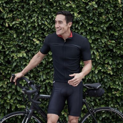 Keahu Kahuanui posing for a photo shoot while holding his bicycle.